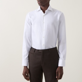 Model wearing Canali white single cuff regular cotton formal shirt with dark brown tailored trousers.