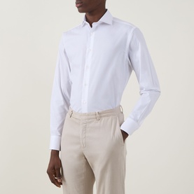 Model wearing Canali Travel Stretch Single-Cuff Shirt in white with cutaway collar and buttoned cuffs, styled with beige trousers