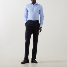 Model wearing Canali Travel Stretch Single-Cuff Shirt in blue with cutaway collar, styled with navy tailored trousers and black loafers.