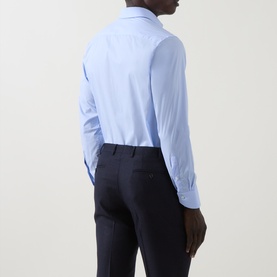 Model wearing Canali Travel Stretch Single-Cuff Shirt in blue, rear view, styled with navy pinstripe trousers.