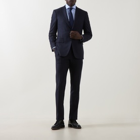 Model wearing Canali Travel Stretch Single-Cuff Shirt in blue, styled with a navy suit, tie, and black leather shoes.