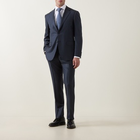 Model wearing Canali D6 Griz Solid Two-Piece Suit in dark blue, styled with a white shirt and blue tie, black Oxford shoes.
