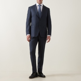 Model wearing Canali D6 Griz Solid Two-Piece Suit in dark blue, styled with white shirt and blue tie, black leather shoes.