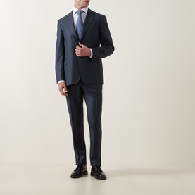 Model wearing Canali D6 Griz Solid Two-Piece Suit in dark blue, single-breasted jacket with notch lapels, styled with light blue shirt and tie.