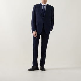 Model wearing Canali dark blue suit with notch lapels, styled with white shirt, navy tie, and black Oxford shoes