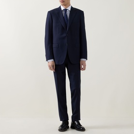 Model wearing Canali dark blue suit with white shirt and tie, styled with black Oxford shoes