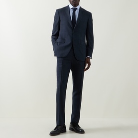 Model wearing Canali navy wool suit, styled with light blue shirt, navy tie and black leather shoes.