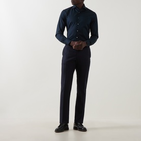 Model wearing Canali navy single cuff regular shirt with matching navy trousers and black leather loafers.
