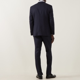 Model wearing Canali D6 Pinstripe Two-Piece Suit in navy wool, rear view, styled with white shirt and dark oxford shoes.