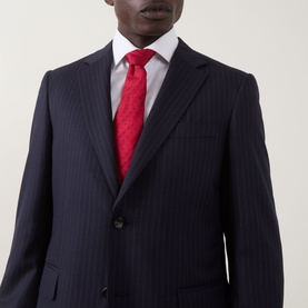 Model wearing Canali D6 Pinstripe Two-Piece Suit in navy, styled with a white shirt and red tie.
