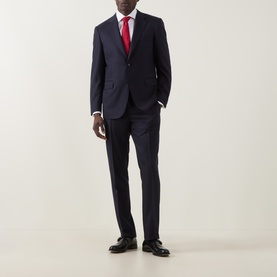 Model wearing Canali D6 Pinstripe Two-Piece Suit in navy wool, styled with a red tie and black dress shoes.