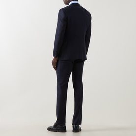 Model wearing Canali dark blue wool suit, back view, styled with white dress shirt and black leather shoes