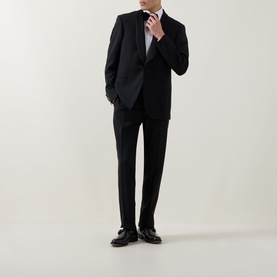Model wearing Canali black suit with slim-cut trousers, styled with white shirt and black leather loafers