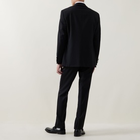 Model wearing Canali black suit, rear view, styled with black dress shoes and white dress shirt.