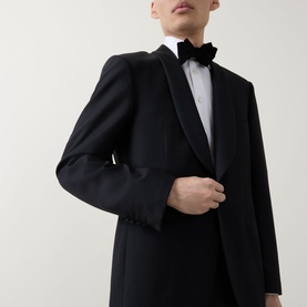Model wearing Canali black suit jacket with satin lapels, styled with white dress shirt and black velvet bow tie