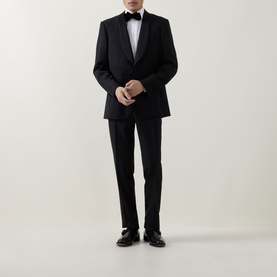 Model wearing Canali black suit with shawl lapel jacket, styled with white dress shirt, black bow tie and black leather shoes
