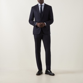 Model wearing Canali D8 Flannel Two-Piece Suit in navy, styled with white shirt, tie, and black leather shoes