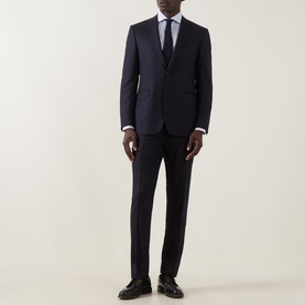 Model wearing Canali D8 Flannel Two-Piece Suit in navy, styled with white shirt, dark tie and black leather shoes.