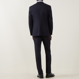 Model wearing Canali D8 Flannel Two-Piece Suit in navy, rear view, styled with white shirt and black dress shoes.