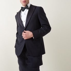 Model wearing Canali D8 Two-Piece Suit in navy, single-breasted jacket with satin peak lapels, styled with white dress shirt and black bow tie.