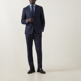 Model wearing Canali D8 Textured Two-Piece Suit in navy, styled with a light blue shirt, blue tie, and dark leather shoes.