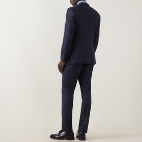 Model wearing Canali D8 Textured Two-Piece Suit in navy, rear view, styled with a light blue shirt and black leather shoes.
