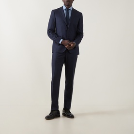 Model wearing Canali D8 Textured Two-Piece Suit in navy, styled with a light blue shirt and navy tie, dark leather shoes.