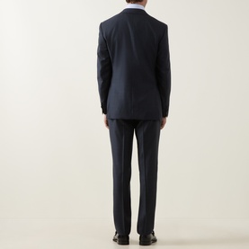 Model wearing Canali D8 Tonal Check Two-Piece Suit in navy, rear view showing single-breasted jacket with rear vents and slim-leg trousers.