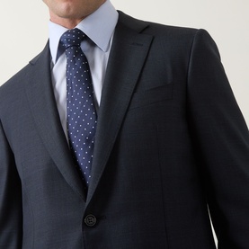 Model wearing Canali D8 Tonal Check Two-Piece Suit in navy, styled with a light blue shirt and navy polka dot tie.