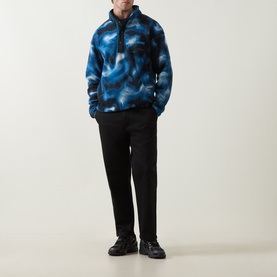Model wearing Columbia Helvetia II Printed Half Snap Fleece in Phoenix Blue with black trousers and black shoes.