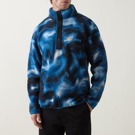 Model wearing Columbia Helvetia&trade; II Printed Half Snap Fleece in Phoenix Blue abstract print with half-snap collar and logo detail.