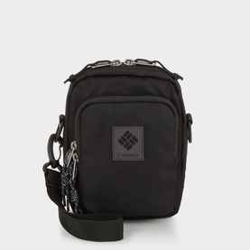 Columbia black nylon crossbody bag with silver-tone zip hardware, rubber logo patch, and adjustable webbing strap