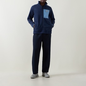 Model wearing Columbia Collegiate Navy fleece half-zip with contrast chest pocket, styled with navy joggers and grey trainers
