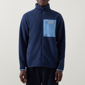 Model wearing Columbia Collegiate Navy full-zip fleece jacket with contrast blue chest pocket and stand collar
