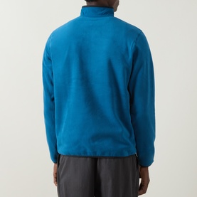 Model wearing Columbia Pacific Arch Logo 200 Zip Fleece Sweatshirt in Phoenix Blue, rear view, paired with grey trousers