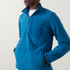 Model wearing Columbia Pacific Arch Logo 200 Zip Fleece Sweatshirt in Phoenix Blue, half-zip neck, chest pocket, styled with white crew-neck tee.