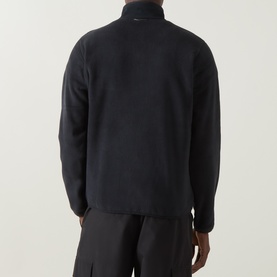 Model wearing Columbia Pacific Arch Logo 200 Zip Fleece Jacket in black, rear view showing zip fastening and long sleeves