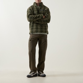 Model wearing Columbia Helvetia&trade; II Printed Half Snap Fleece in Stone Green Twills print, styled with olive cargo trousers and trail trainers.