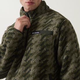 Model wearing Columbia Helvetia&trade; II Printed Half Snap Fleece in Stone Green Twills, shown zipping up the half-snap collar