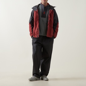 Model wearing Columbia Sequoia Grove II Half Zip Fleece Jacket in Sedona Sage/Shark, styled with dark waterproof trousers and grey trainers.