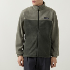 Model wearing Columbia fleece jacket in Stone Green, two-tone colourblock design with stand collar and full zip