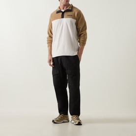 Model wearing Columbia Steens Mountain II Half Snap Fleece Jacket in Dark Stone/Delta colourblock, styled with black cargo trousers and trail