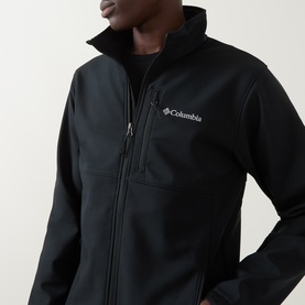 Model wearing Columbia Ascender&trade; Hiking Softshell Jacket in black with zip fastening, chin guard, chest pocket and logo detail