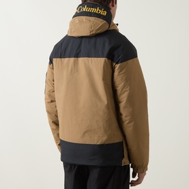 Model wearing Columbia Challenger II Pullover Anorak in Delta/Black colourblock, rear view, styled with black trousers.