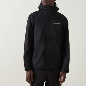 Model wearing Columbia black hooded zip-up jacket with chest logo, lightweight polyester shell and front zip pockets.
