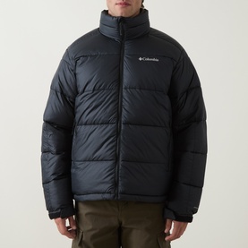 Model wearing Columbia Pike Lake&trade; II Puffer Jacket in black, featuring quilted padded design, stand collar, and front zip fastening, styled with