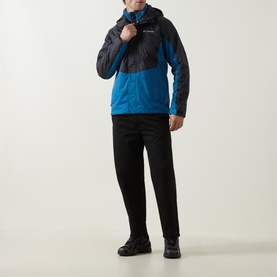 Model wearing Columbia Pouring Adventure&trade; III Waterproof Hiking Jacket in Black and Phoenix Blue colourblock, styled with black trousers and dark