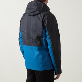 Model wearing Columbia Pouring Adventure&trade; III Waterproof Hiking Jacket in Black/Phoenix Blue colourblock, rear view, with black trousers.