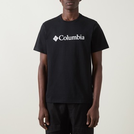 Model wearing Columbia CSC Basic Logo T-Shirt in black, with white chest logo, round neck and short sleeves.
