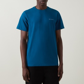 Model wearing Columbia CSC Logo Back Graphic T-Shirt in Phoenix Blue, round neck, short sleeves, small chest logo visible.